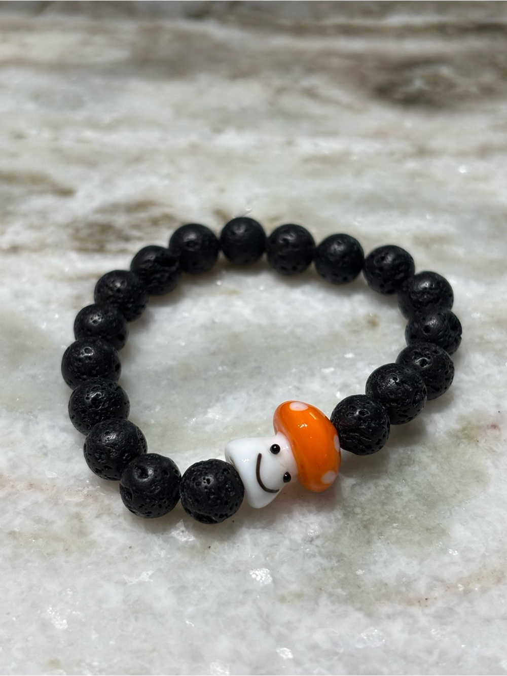 Black Lava Bead Bracelet with Orange Mushroom Charm